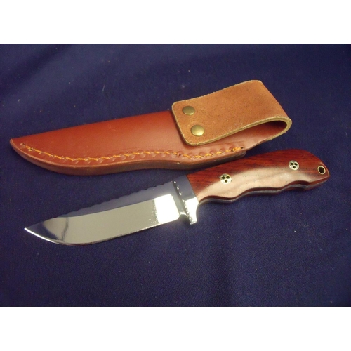 75 - Small 3 1/4 inch bladed skinning type sheath knife with two piece wooden grip and leather sheath