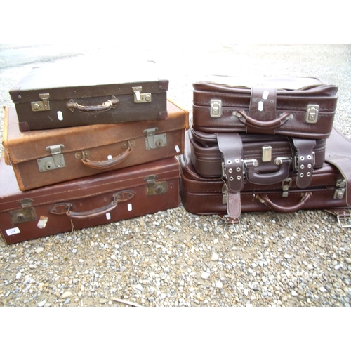 252 - Vintage brown leather suitcase, another similar and a small selection of other later luggage