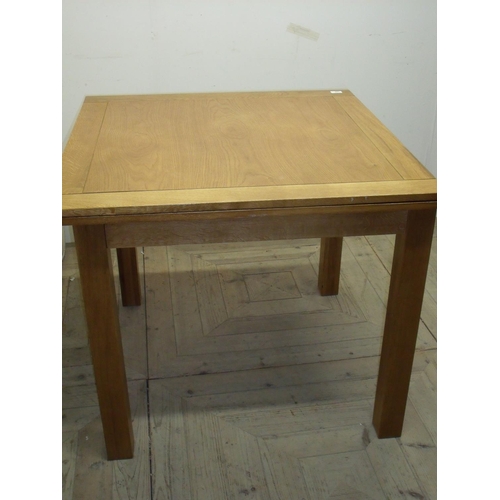 329 - Modern medium oak folder over extending dining table on square tapering supports (90cm x 90cm x 78cm... 