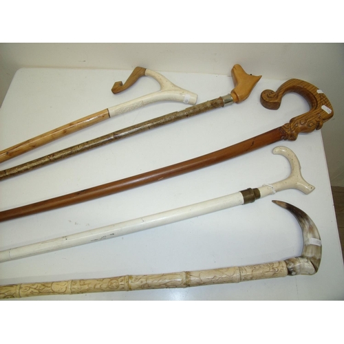 44 - Group of five various assorted walking sticks and canes including carved wood handles, horses head e... 