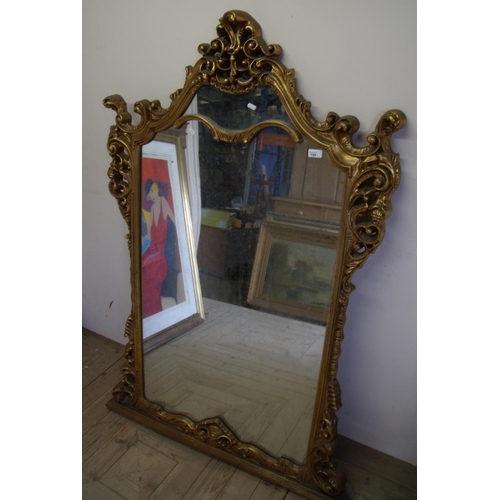 199 - Extremely large modern gilt frame over mantle mirror with elaborate frame (97cm x 152cm)
