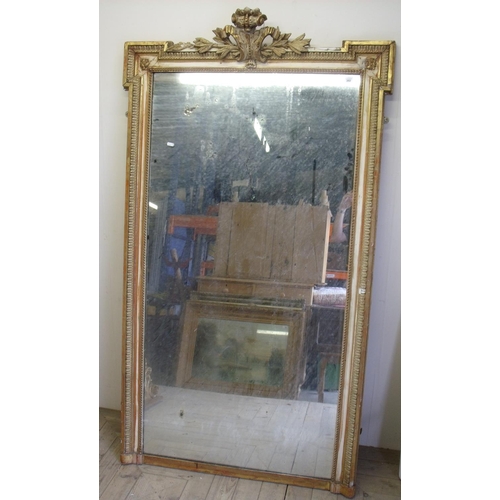 202 - Large 19th C gilt framed console mirror with plasterwork crested top (104cm x 180cm)