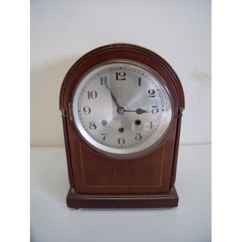 65 - Edwardian mahogany inlaid arch top steel faced chiming mantle clock on raised bun feet, the movement... 