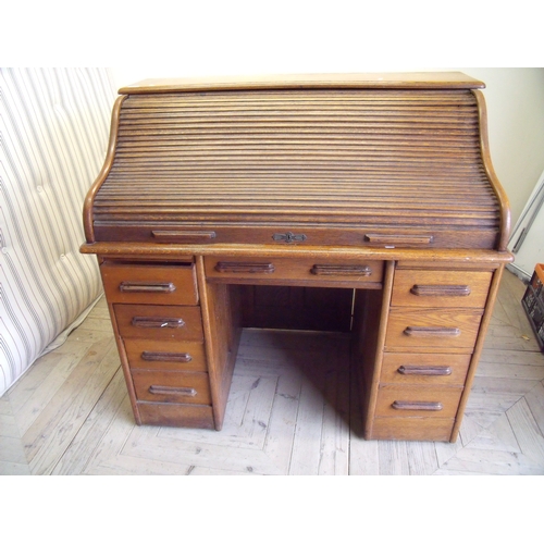 134 - Edwardian oak roll top desk on twin four drawer pedestals with panelled detail to the back and sides... 
