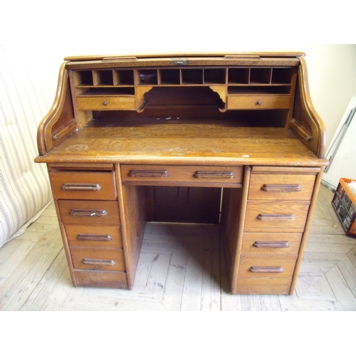 134 - Edwardian oak roll top desk on twin four drawer pedestals with panelled detail to the back and sides... 