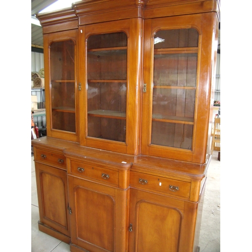 136 - Victorian mahogany break front bookcase with three upper glazed cupboard doors above three drawers a... 