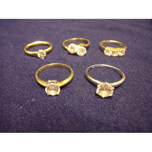 104 - Group of five dress rings, four in 9ct yellow gold set with CZ stones and one 9ct white gold solitai... 