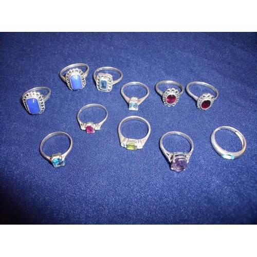 105 - Group of eleven silver dress rings set with various coloured stones, marquisette etc