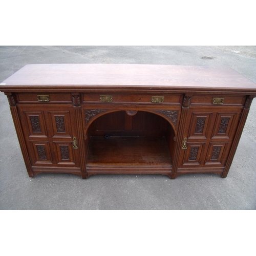 280 - Late Victorian oak sideboard with central frieze drawer above open centre flanked by two further dra... 