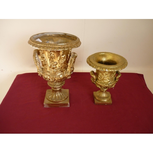 33 - Pair of plasterwork gilt painted urns of classical design (34cm & 24cm high)