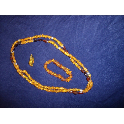 44 - Selection of amber jewellery, mostly in a raw state including necklace, bracelet and brooch