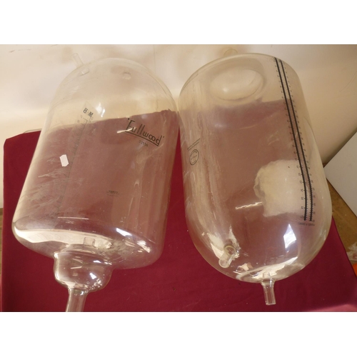 165 - Pair of glass milking cylinders (overall length 65cm)