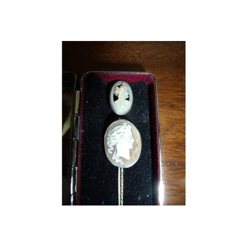 136 - Yellow metal mounted cameo stock pin and a similar carved Mother or Pearl stock pin in white metal (... 