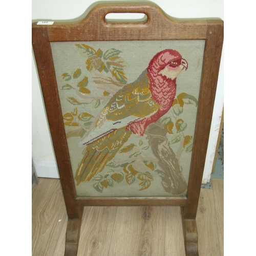 189 - Robert Thompson 'Mouseman' oak fire screen with inset wool work embroidered panel of a parakeet (47c... 