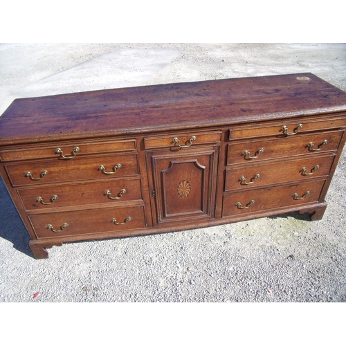 415 - 18th/19th C oak dresser base with central drawer above panelled and inlaid cupboard door flanked by ... 