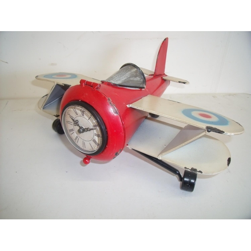 47 - Modern painted tin plate clock in the form of a bi-plane