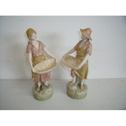 67 - Pair of Royal Dux figures depicting young couple with basket, the base marked 2457 & 2456 (27cm high... 