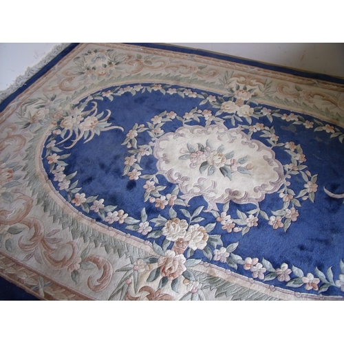 451 - Large blue & beige ground Chinese woollen rug with central floral panel (185cm x 300cm)