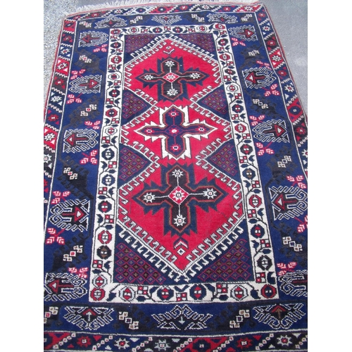 453 - Blue and red ground Persian style woollen rug (124cm x 180cm)