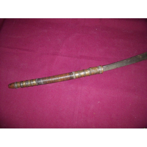 102 - Burmese Dha sword with 18.5nch slightly curved single fullered blade and double handed brass mounted... 