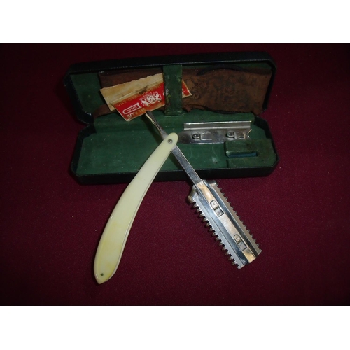 110 - Unusual cased cut throat razor with ivory effect grips and an unusual cutting head with attachments