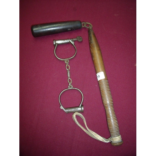 19 - Pair of steel police style handcuffs with key and a hardwood flail type club with turned wood shaft ... 
