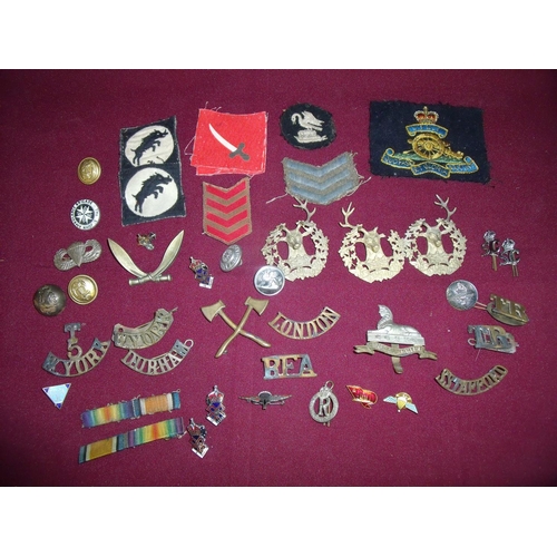 38 - Selection of various military badges, shoulder titles, cloth arm badges etc in one box