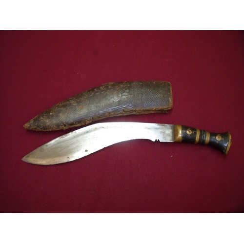 82 - Kukri knife with 11.5 inch blade with brass and wood grip complete with leather sheath (A/F)