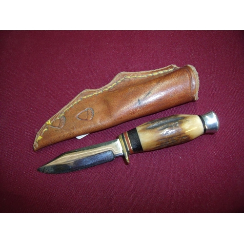 87 - Miniature sheath knife with 2 1/4 inch blade turned antler grip and tooled leather sheath