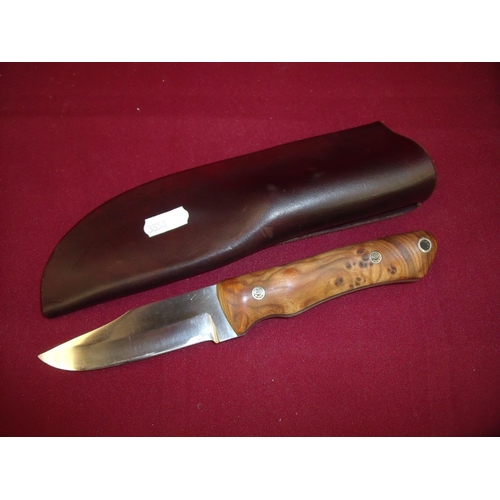 89 - Custom made sheath knife with 4 inch blade and two piece burr wood grip complte with leather sheath