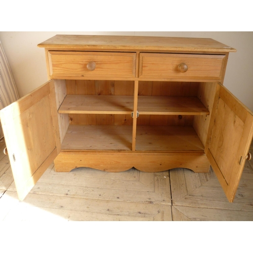 363 - Waxed pine side cabinet with two drawers above two panelled cupboard doors (106cm x 42cm x 84cm)