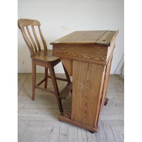 364 - Victorian pine raised clerks desk with sloped hinged top above single panelled door cupboard to the ... 