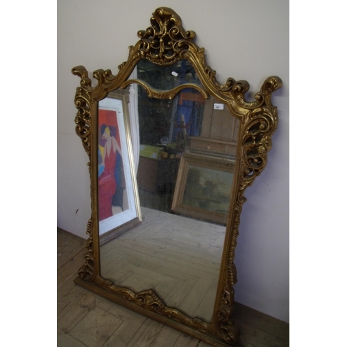 378 - Extremely large modern gilt frame over mantle mirror with elaborate frame (97cm x 152cm)