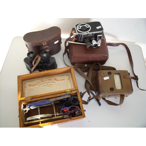 22 - Cased binoculars, vintage cine camera, amp meter and an electric shock type machine