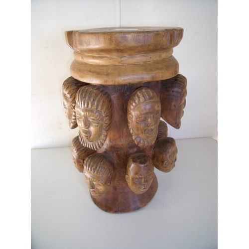 243 - Carved hardwood 'Many Faced' stool (47cm high)