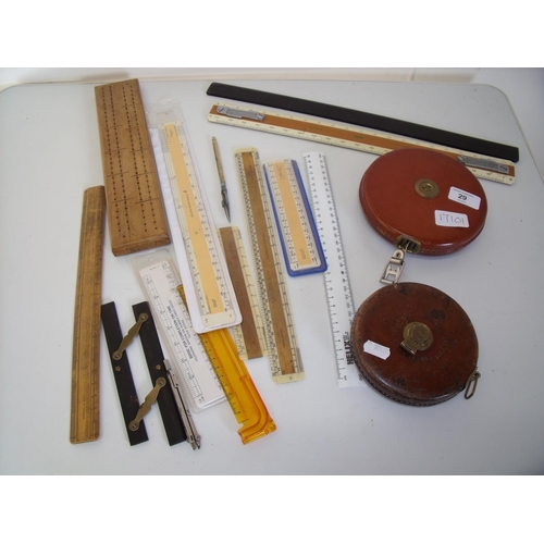 29 - Two leather cased tapes, various rulers and measuring devices