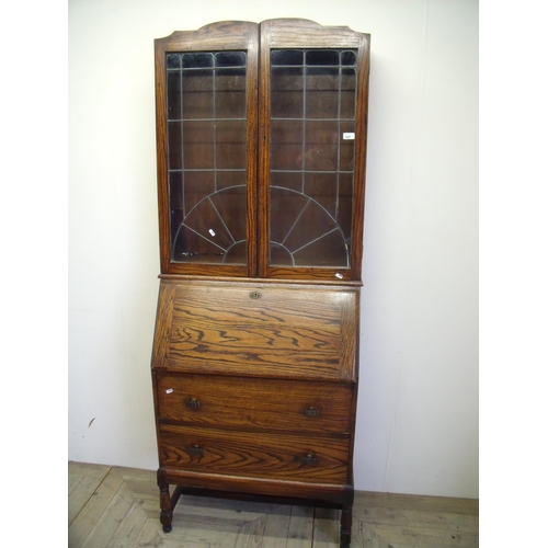 329 - 1930s oak bureau bookcase with lead glazed doors above fall front and two drawers (width 75cm)