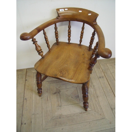 336 - Elm smokers bow type chair on turned supports and H shaped under stretcher