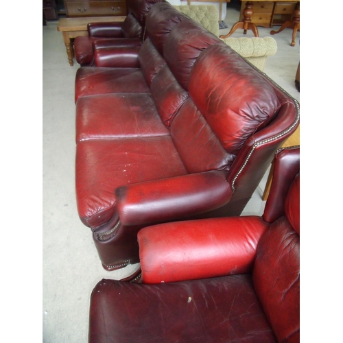 348 - Three piece wingback leather suite comprising of three seat sofa and a pair of matching armchairs