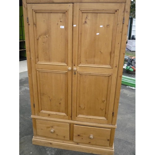 350 - Waxed pine double door wardrobe with two drawers to the base (116cm x 61cm x 195cm)