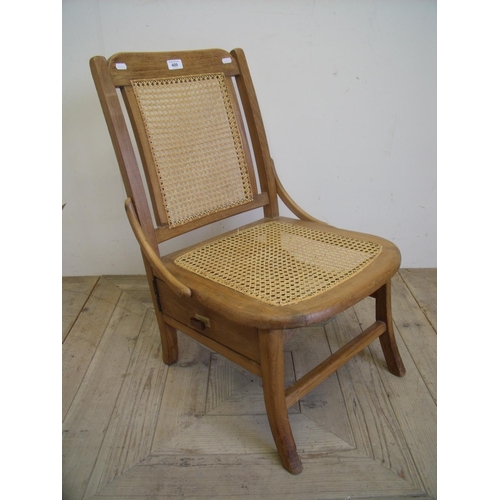 409 - Early 20th C bedroom chair with Bergere seat and back, with storage drawer underneath