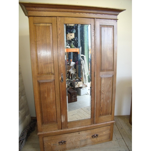 434 - Early 20th C oak single wardrobe with bevelled mirror door and fielded panels above a single drawer