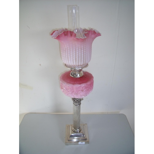 57 - Late Victorian oil lamp with silver plated Corinthian column base with pink glass reservoir and shad... 