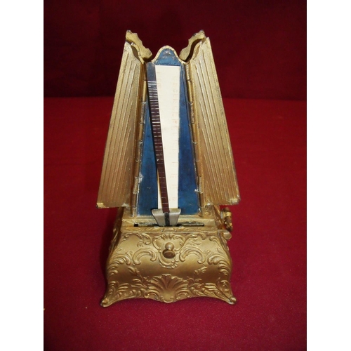 100 - Unusual Victorian cased gilt metal finished metronome with two folding doors (19cm high)