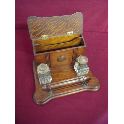 112 - Edwardian oak desk set comprising of raised two sectional letter rack with hinged lid, a pair of squ... 