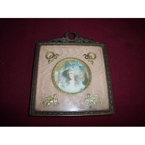 122 - 19th C picture frame with easel stand back in gilt metal regency swag frame with central circular pa... 