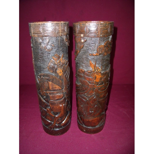 49 - Pair of 20th C Japanese carved bamboo vases depicting fighting warriors (42cm high)