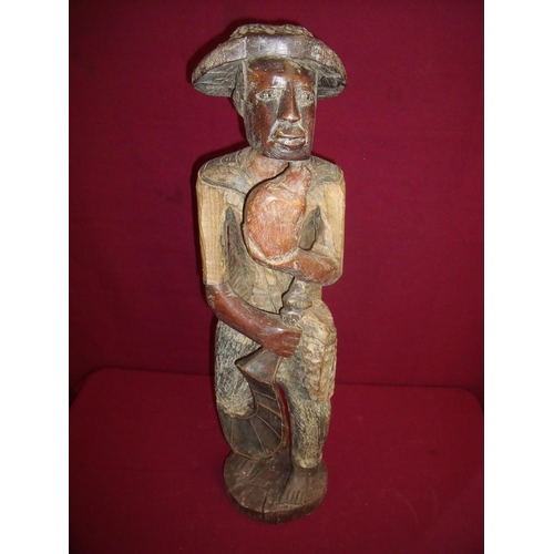 54 - Carved Bali style hard wood figure of a gentleman with knife & fruit (72cm high)