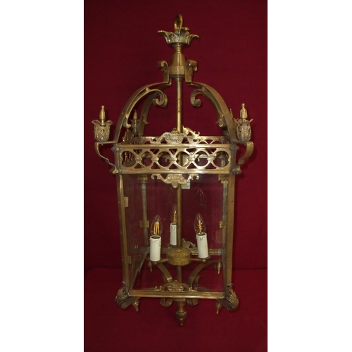 66 - Extremely large brass glazed hall lantern with elaborate scroll detail enclosed by four glass panels... 