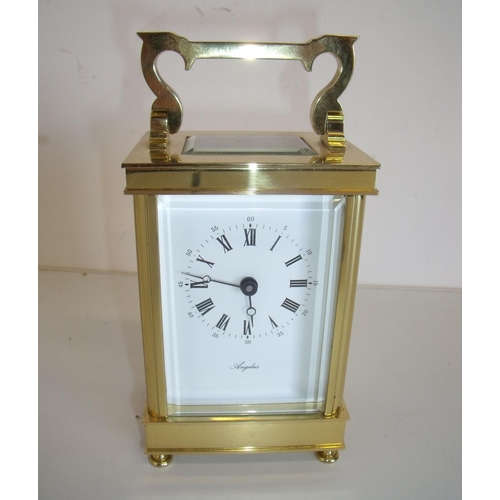 16 - Quality modern brass cased bevelled edged glazed carriage clock marked Angelus